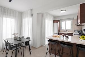a kitchen with a table and chairs in a kitchen at Ethereal Residence by Nomads in Paphos