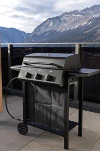 a grill sitting on a table on a balcony at Huawa Appartements in Öblarn