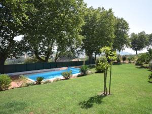 a garden with a swimming pool and trees at Cozy Villa with Private Swimming Pool in Carreiros