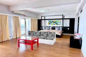 a living room with a couch and a bed at Pailyn Hotel Phitsanulok in Phitsanulok