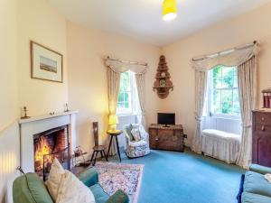 a living room with a couch and a fireplace at The Ivy Wing in Slickly