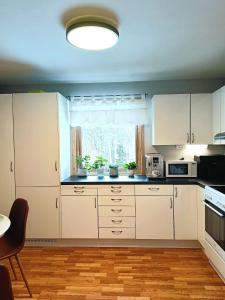 a kitchen with white cabinets and a window at Holiday home in Steinkjer in Steinkjer