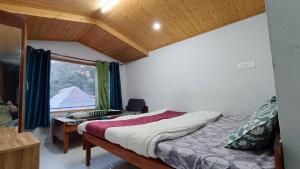 a bedroom with a bed and a window at The Hostelers Homestay Shimla - Near ISBT, Bypass MC Parking and HPU in Shimla