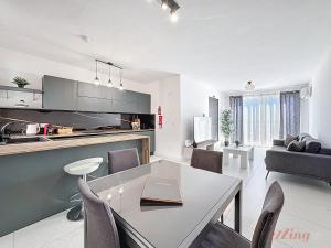 a kitchen and living room with a table and chairs at Stylish Seaview Retreat in St Pauls Bay in St. Paul's Bay