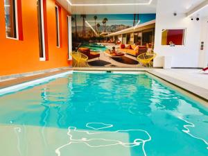 a swimming pool in the middle of a building with a swimming pool at Appartement cosy ambiance Malibu dans résidence avec piscine 2 pers 1 chambre in Neuf-Mesnil
