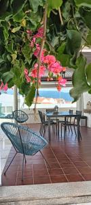 a group of tables and chairs in a room with flowers at Casa de Âncora in Vila Praia de Âncora
