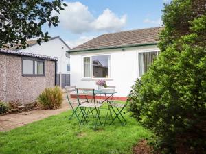 a table and chairs in the yard of a house at Castle Cove in Abergele