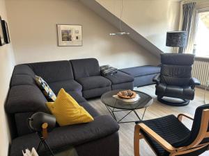 a living room with a couch and a chair at Grandezza Ferienwohnungen Erpeldinger in Ellenz-Poltersdorf