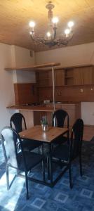 a dining room table with chairs and a lamp at Magura Camp in Małastów +17 photos
