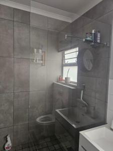 a bathroom with a shower and a toilet and a sink at Quarter 5, Two Zero Four in Oakdale
