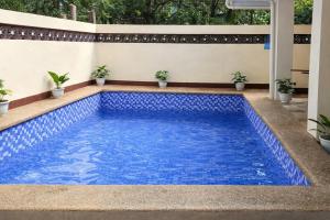 a swimming pool with blue water in a house at Bahay Domingo Guesthouse & Private Pool in Bagac