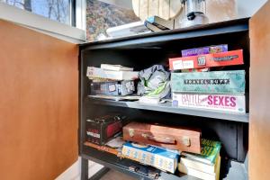 a book shelf filled with books and other books at Lula Lake Cabin in Rising Fawn