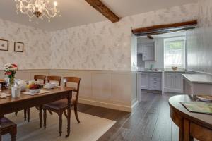 a kitchen with a table and chairs and a dining room at 3 Bed in Sedbergh oc-ds960 in Milnthorpe
