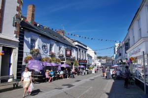 a street with people walking down a street with buildings at 1 Bed in Wadebridge oc-p00232 in Wadebridge