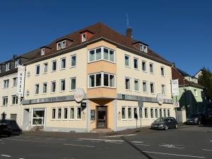 a large building on the corner of a street at Südhotel in Paderborn