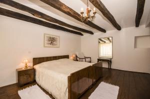 a bedroom with a large bed and a chandelier at House Elena in Lindar