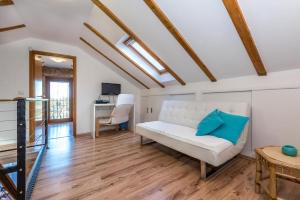 a living room with a white couch and a desk at Villa Rural wellness in Validžići +32 photos