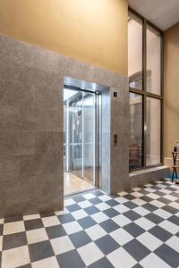 a lobby with a glass door and a checkered floor at Pod Błękitnymi Podkowami in Wrocław +163 photos