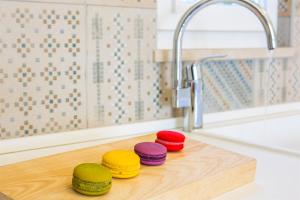 four colorful disks sitting on a cutting board next to a sink at Villa Eni in Primošten