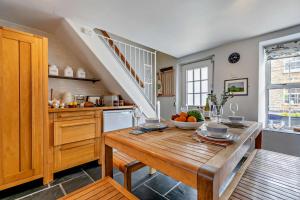 a kitchen with a table with a bowl of fruit on it at 2 Bed in Edmonton oc-p00586 in Wadebridge