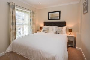 a bedroom with a white bed and a window at 2 Bed in Edmonton oc-p00586 in Wadebridge