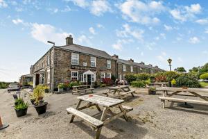 a group of picnic tables in front of a building at 2 Bed in Edmonton oc-p00586 in Wadebridge