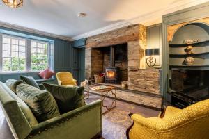 a living room with a couch and a fireplace at 5 Bed in Padstow oc-p00595 in Padstow