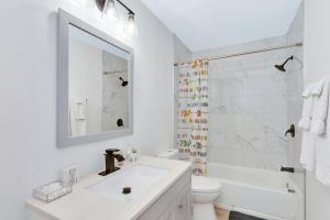 a white bathroom with a sink and a shower at Lula Lake Cabin in Rising Fawn +39 photos