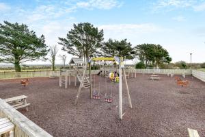 a playground with a swing set in a park at 2 Bed in Padstow oc-p00551 in Saint Merryn