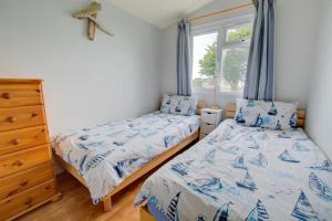 a bedroom with two beds and a window at 2 Bed in Padstow oc-p00551 in Saint Merryn