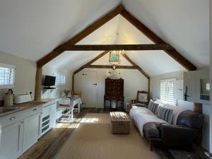 a living room with a couch in the middle of a kitchen at The Hen House in North Huish