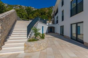 a staircase leading to a white building with stairs at Villa Jackie in Bribir
