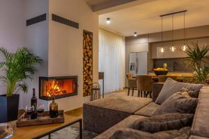 a living room with a couch and a fireplace at Villa Jackie in Bribir