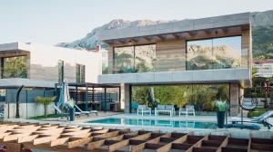 a house with a swimming pool in front of it at Villa Lorkia in Baška