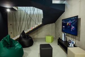 a living room with a tv and a couch at Villa Lorkia in Baška