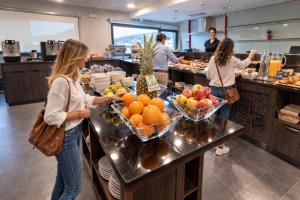 a group of people standing in a kitchen preparing food at Hotel Apartamentos San Fermín Pamplona in Pamplona +125 photos