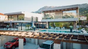 a house with a car parked in front of it at Villa Lorkia in Baška