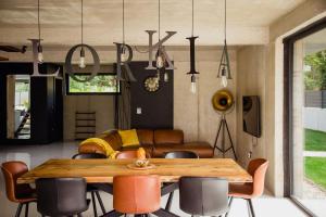 a dining room with a wooden table and chairs at Villa Lorkia in Baška