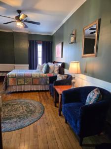 a living room with a bed and a couch at Firehouse Inn in Barre +53 photos