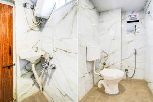 a bathroom with a toilet and a sink at Super Collection O Hingna Road in Nagpur