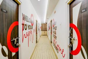 a hallway with red writing on the walls at Super Collection O Hingna Road in Nagpur