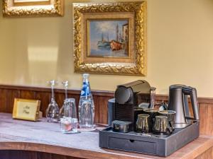 a counter with a coffee maker and other items on it at Pipers Lodge in Shiroka Laka