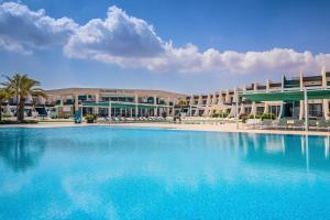 a large swimming pool in front of a hotel at Occidental Mar Menor in Cartagena
