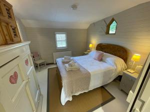 a small bedroom with a bed and a window at The Hen House in North Huish