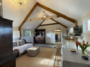 a living room with a couch and a table at The Hen House in North Huish