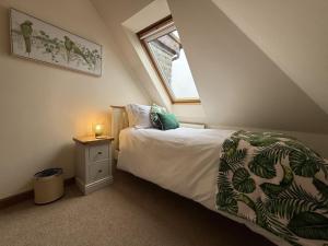 a bedroom with a bed and a window at St Michael's in Kippen