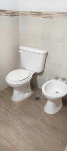 a bathroom with a white toilet and a bidet at CASA TEMPORADa 2027 DÚPLEX 2 HABITACIONES in Miramar +5 photos