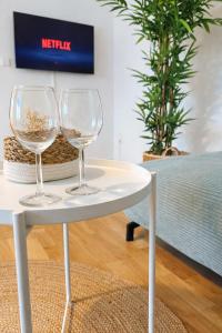 two wine glasses sitting on a white table at Suites in Mödling in Mödling