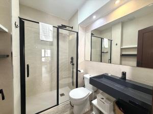 a bathroom with a shower and a toilet and a sink at Apartamento en la playa con piscina - Azcona 6004 in Noja +12 photos