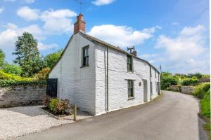 an old white house with a stone wall at 2 Bed in Bodmin oc-p00429 in Saint Teath